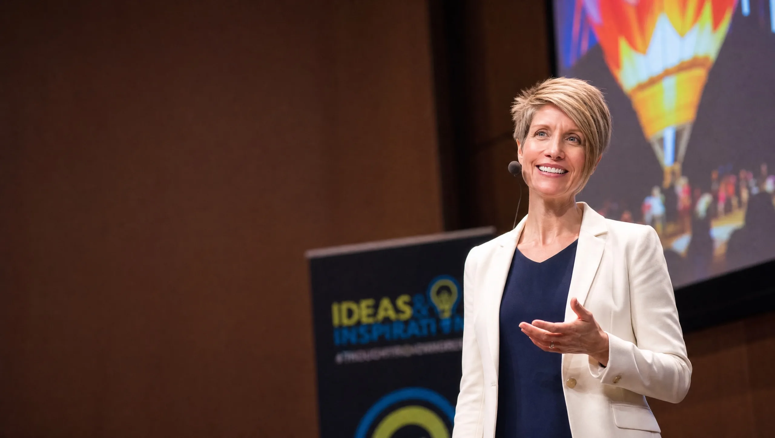 Anji Hallewell speaking on stage
